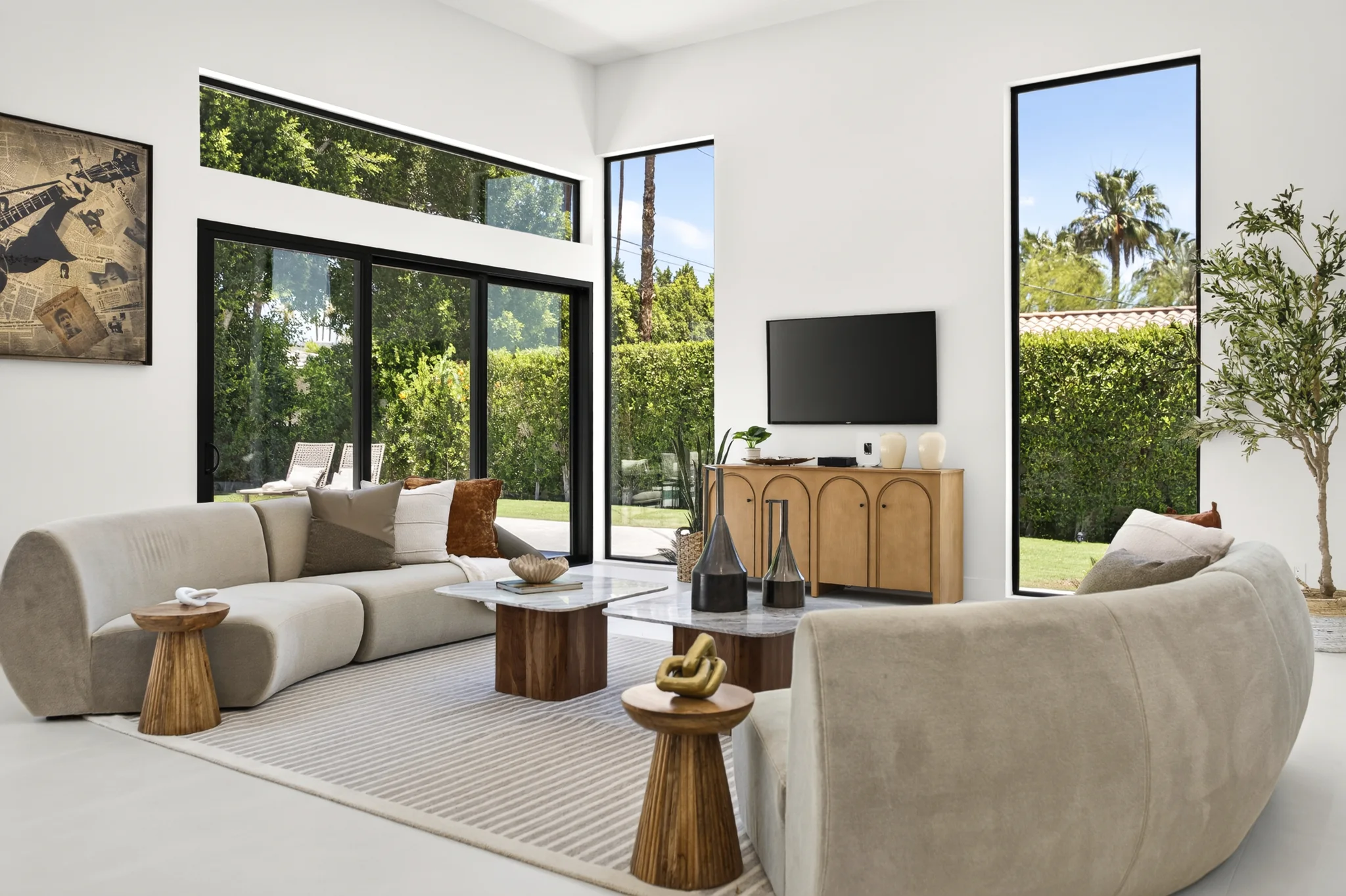 Alameda: curved living room seating beside tall glass doors