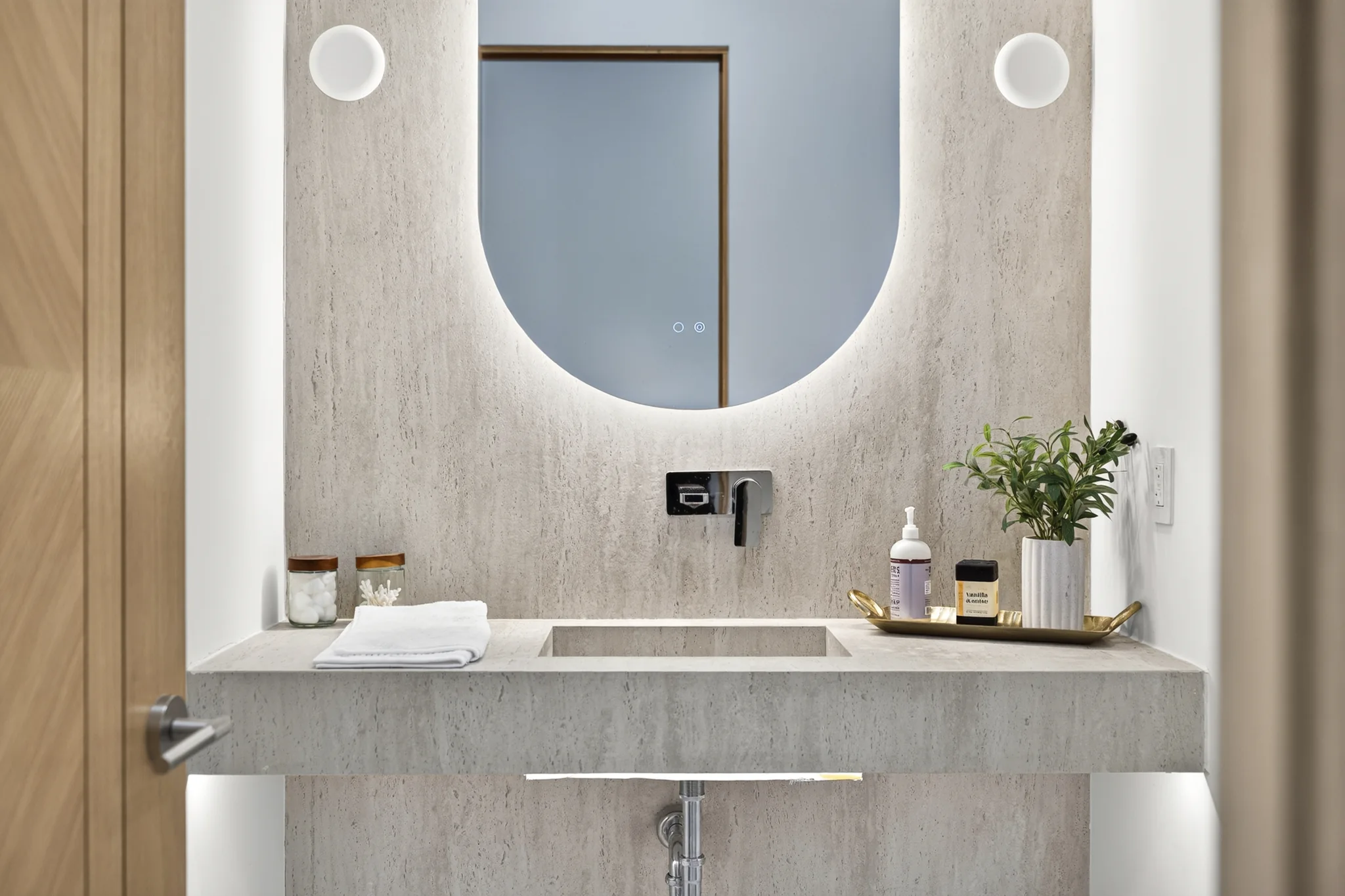Alameda: bathroom vanity with a rounded mirror and wall-mounted fittings