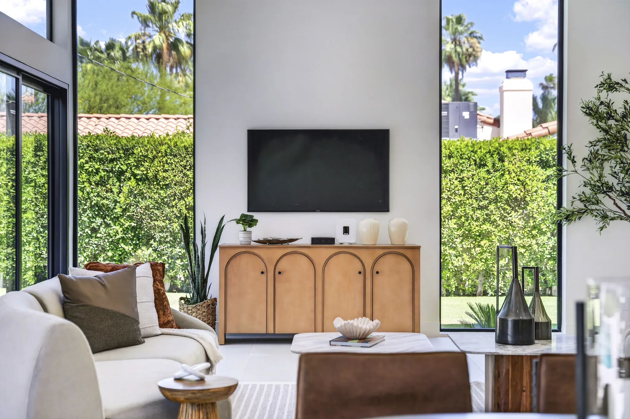 Alameda: living room with a timber media console and garden-facing windows