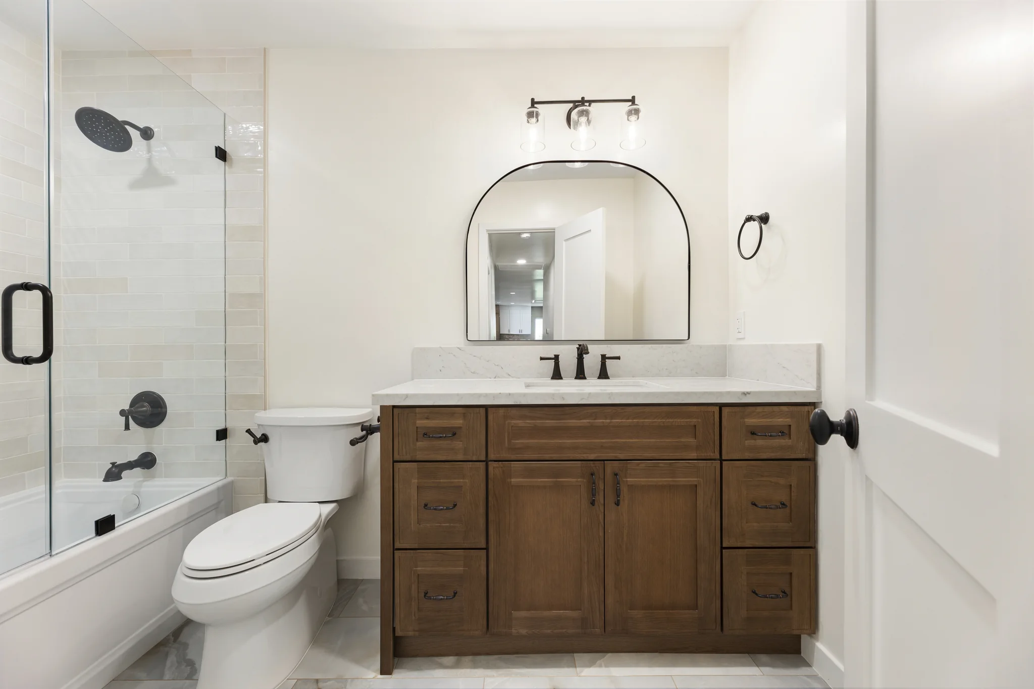 Álvarez: bathroom vanity beside a glass shower enclosure