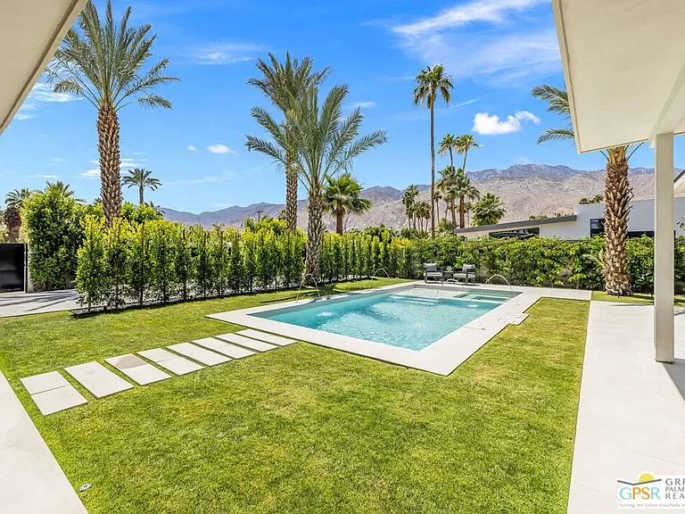 Amado: pool, lawn and palms with mountains beyond