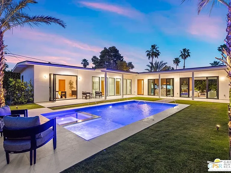 Amado: pool courtyard and illuminated rooms at dusk