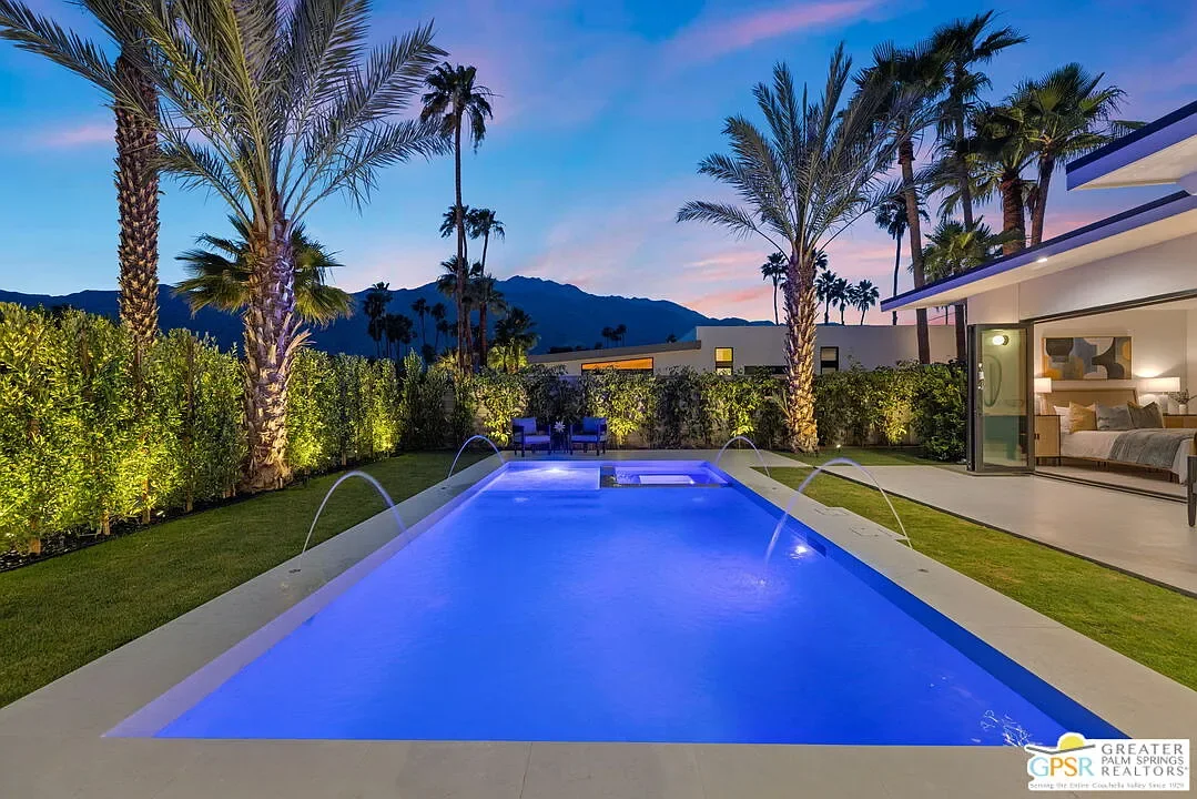 Amado: pool and palm-lined garden at dusk