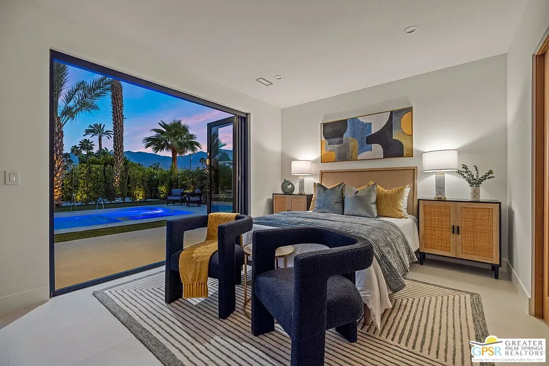 Amado: bedroom opening toward the pool courtyard at dusk