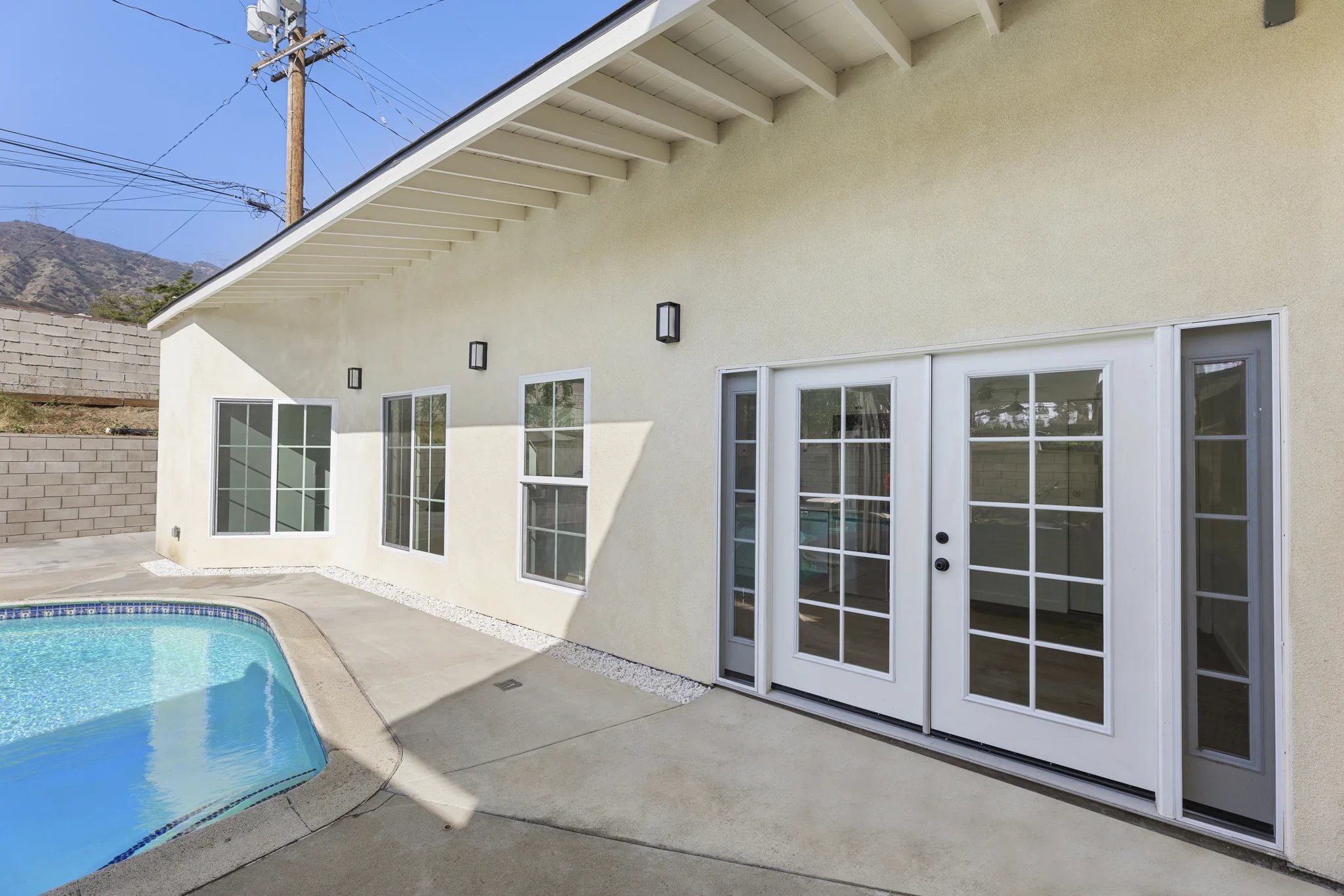 Conata: row of garden-facing doors beside the pool terrace