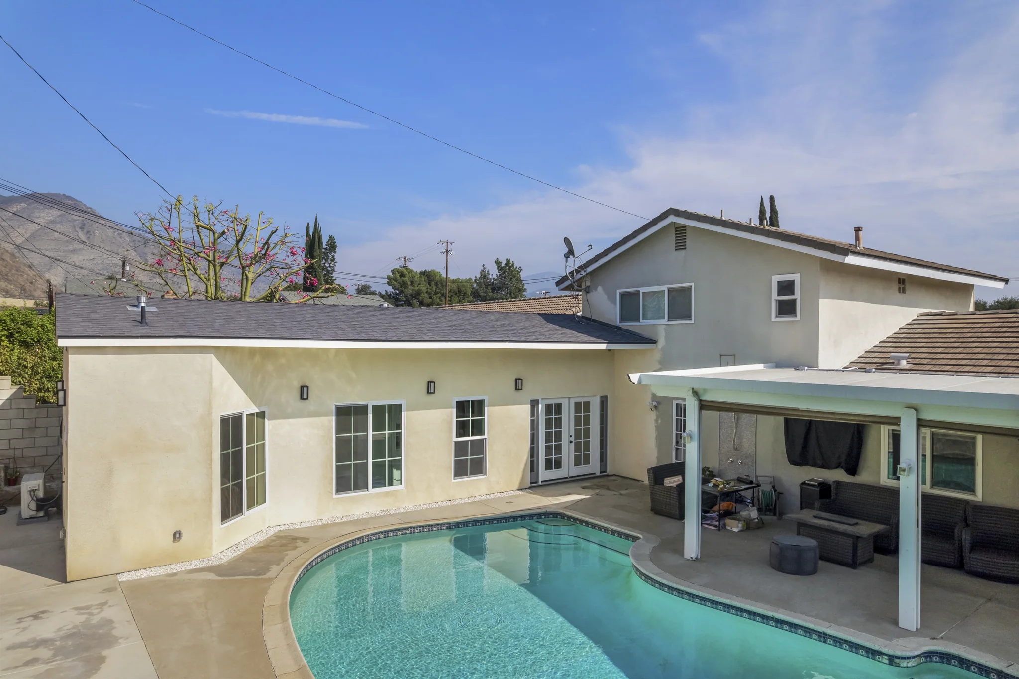 Conata: poolside elevation with windows and a sheltered terrace