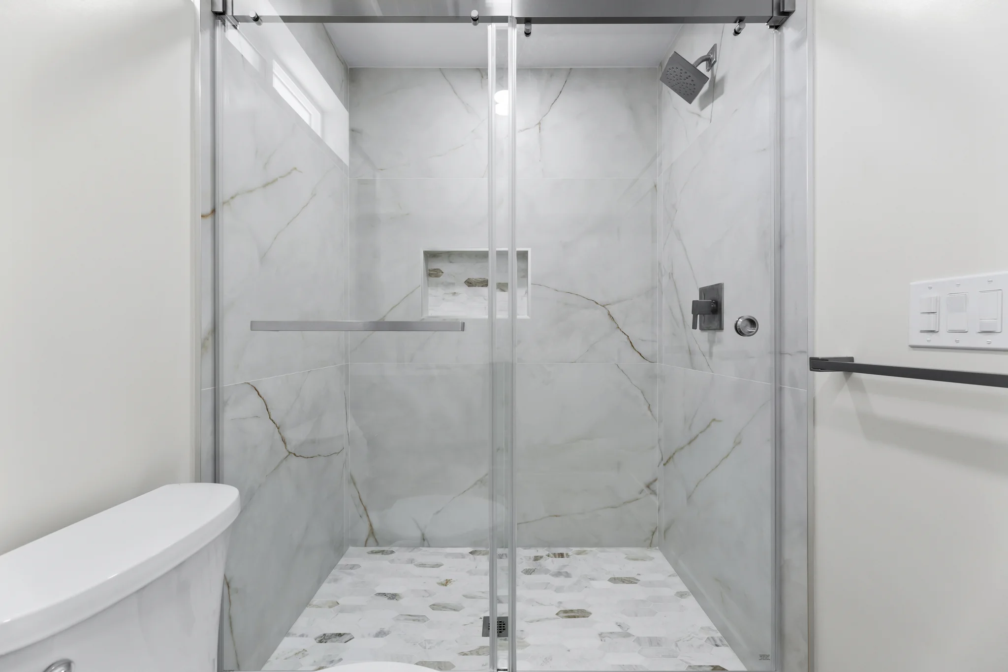 Paso Verde: tiled shower with a glass enclosure