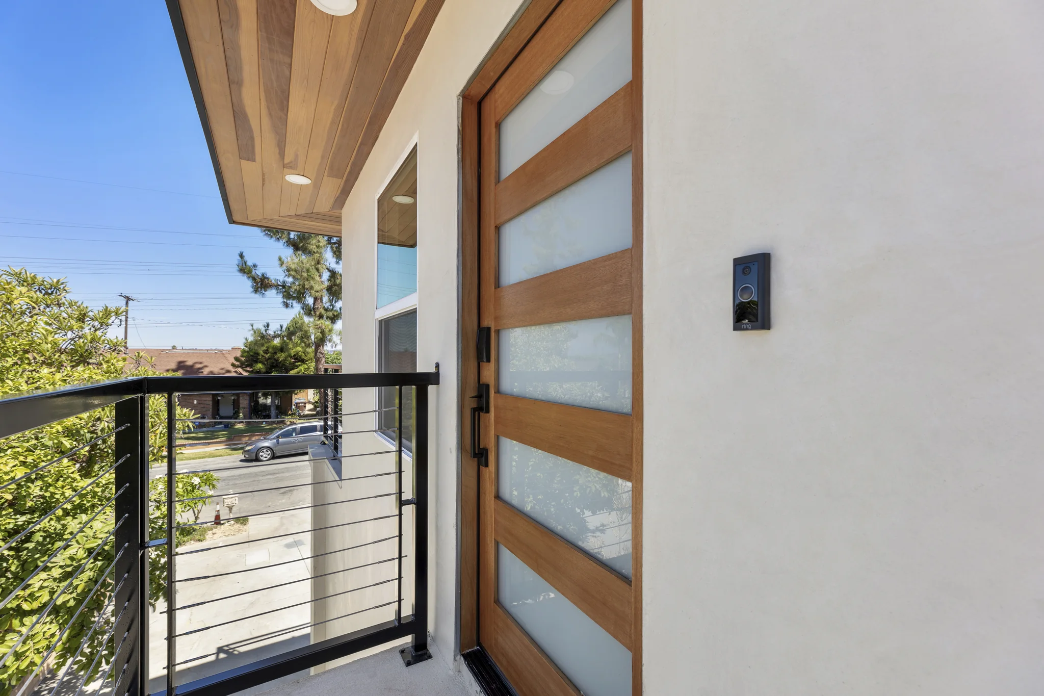Paso Verde: timber entry door beside pale exterior walls