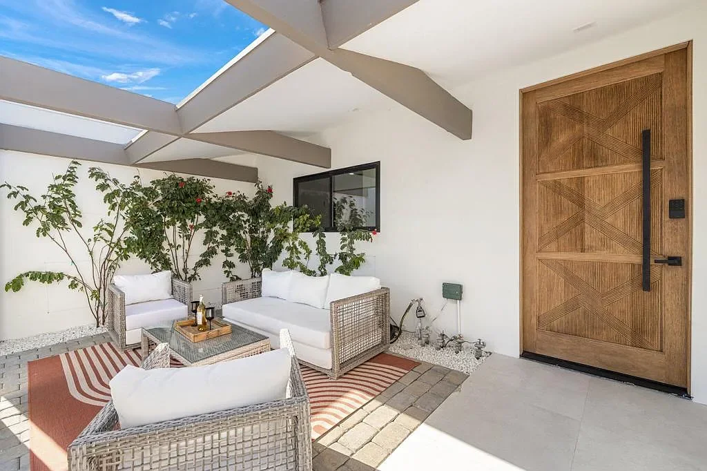 Vista Grande: front porch seating beside a timber entry door