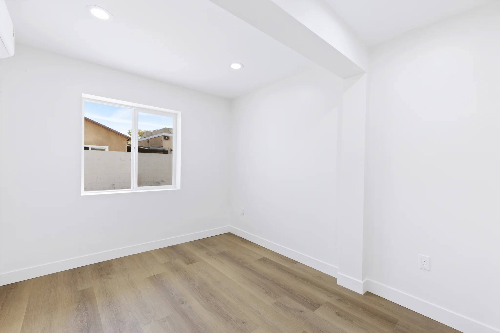 Walnut: bedroom with pale walls and timber-toned flooring