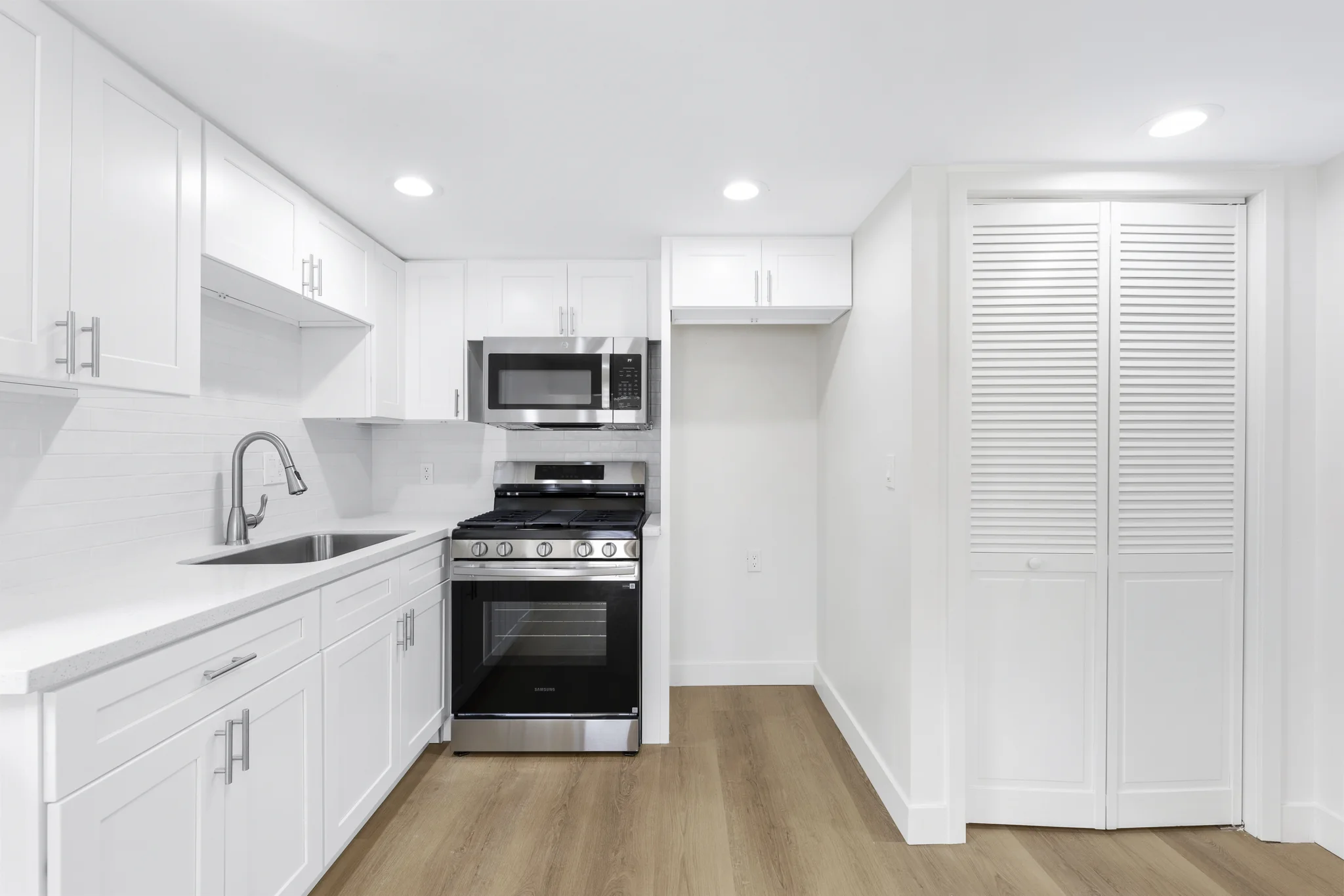 Walnut: bright kitchen with pale cabinetry and a window