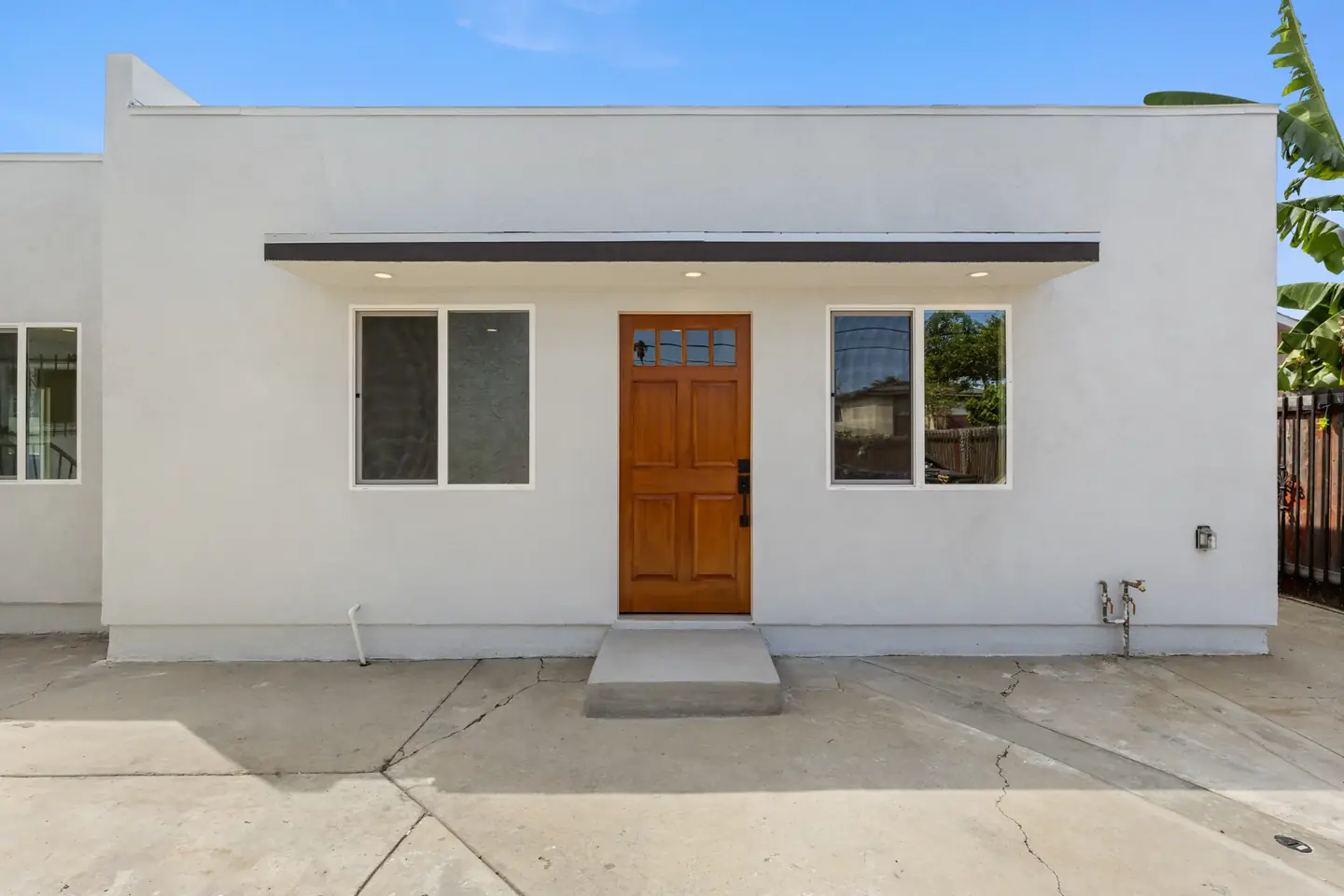 20th St.: white stucco exterior and wood entry door