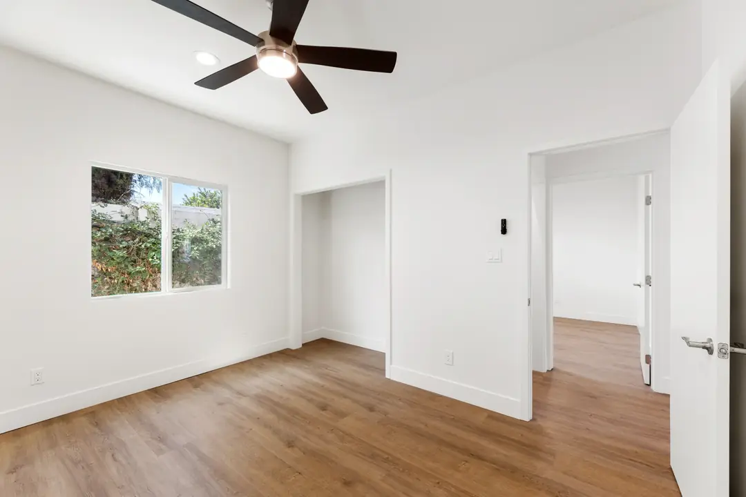20th St.: room with ceiling fan and wood toned flooring
