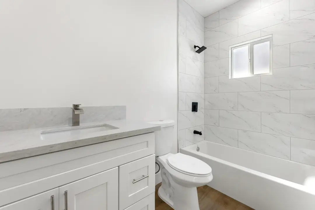 20th St.: bathroom vanity and tiled tub surround