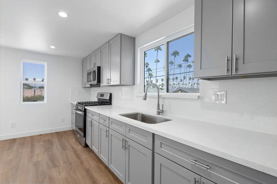 Cimarron: gray kitchen cabinetry beneath a window