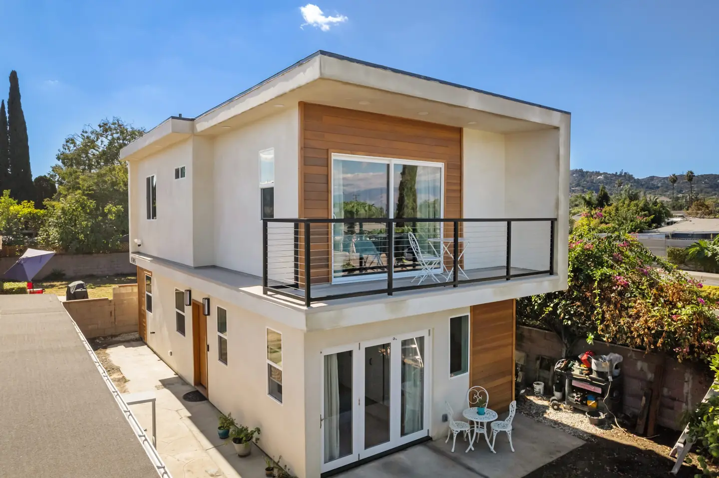 Lancewood: building exterior with balcony and garden facing doors