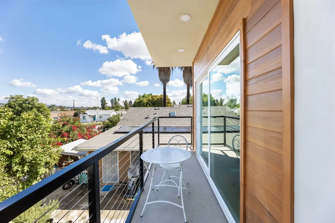 Lancewood: balcony with dark railing and glazed door