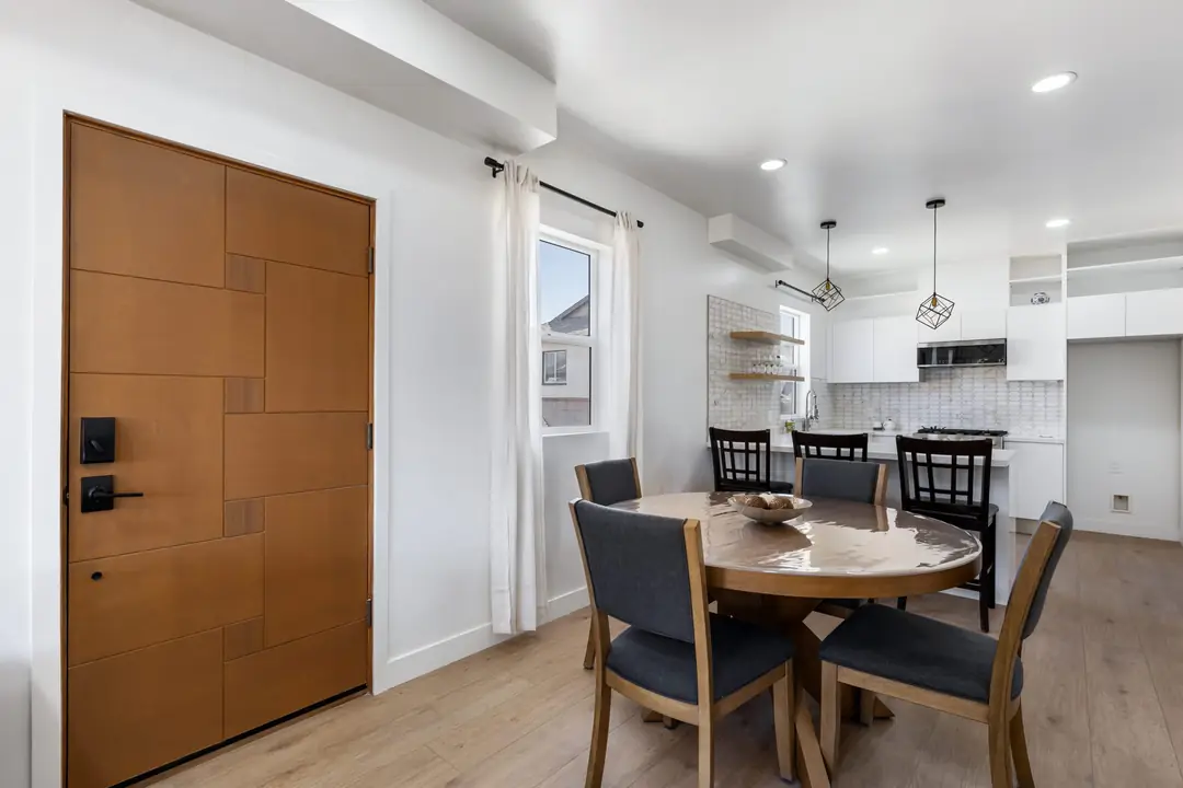 Lancewood: wood entry door beside dining area