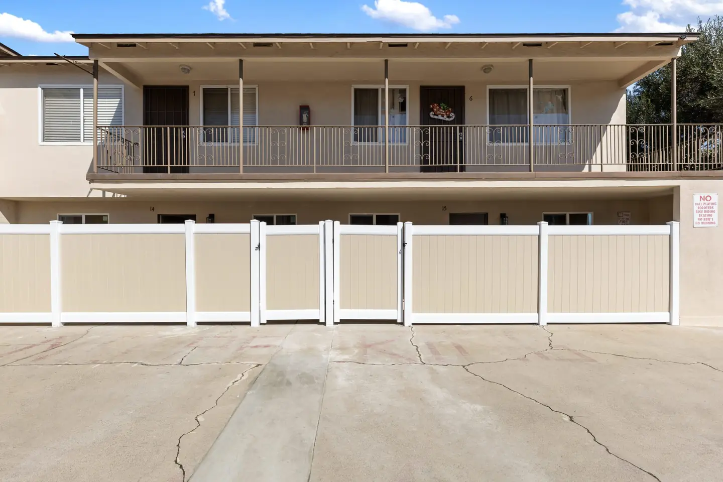 Linden: building exterior with upper walkway and pale front fence