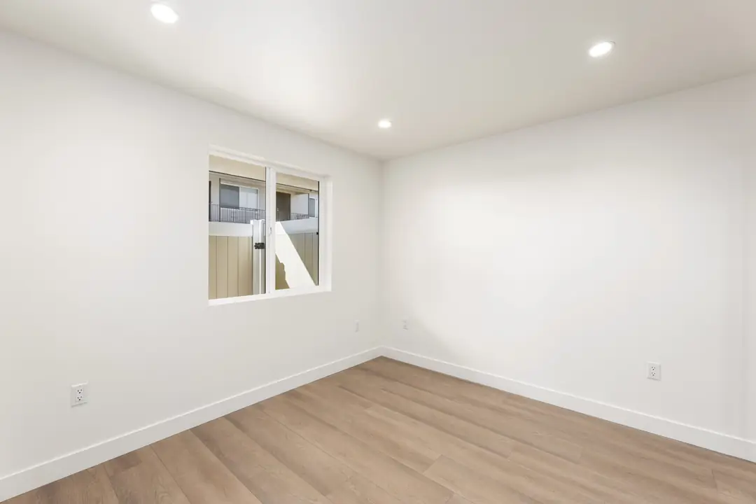 Linden: room with wood toned flooring and corner window