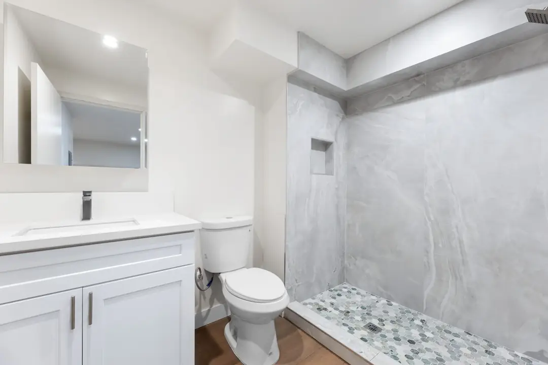Linden: bathroom with tiled shower and white vanity