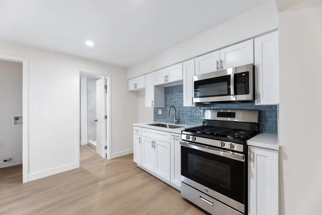 Linden: kitchen with white cabinets and dark appliances