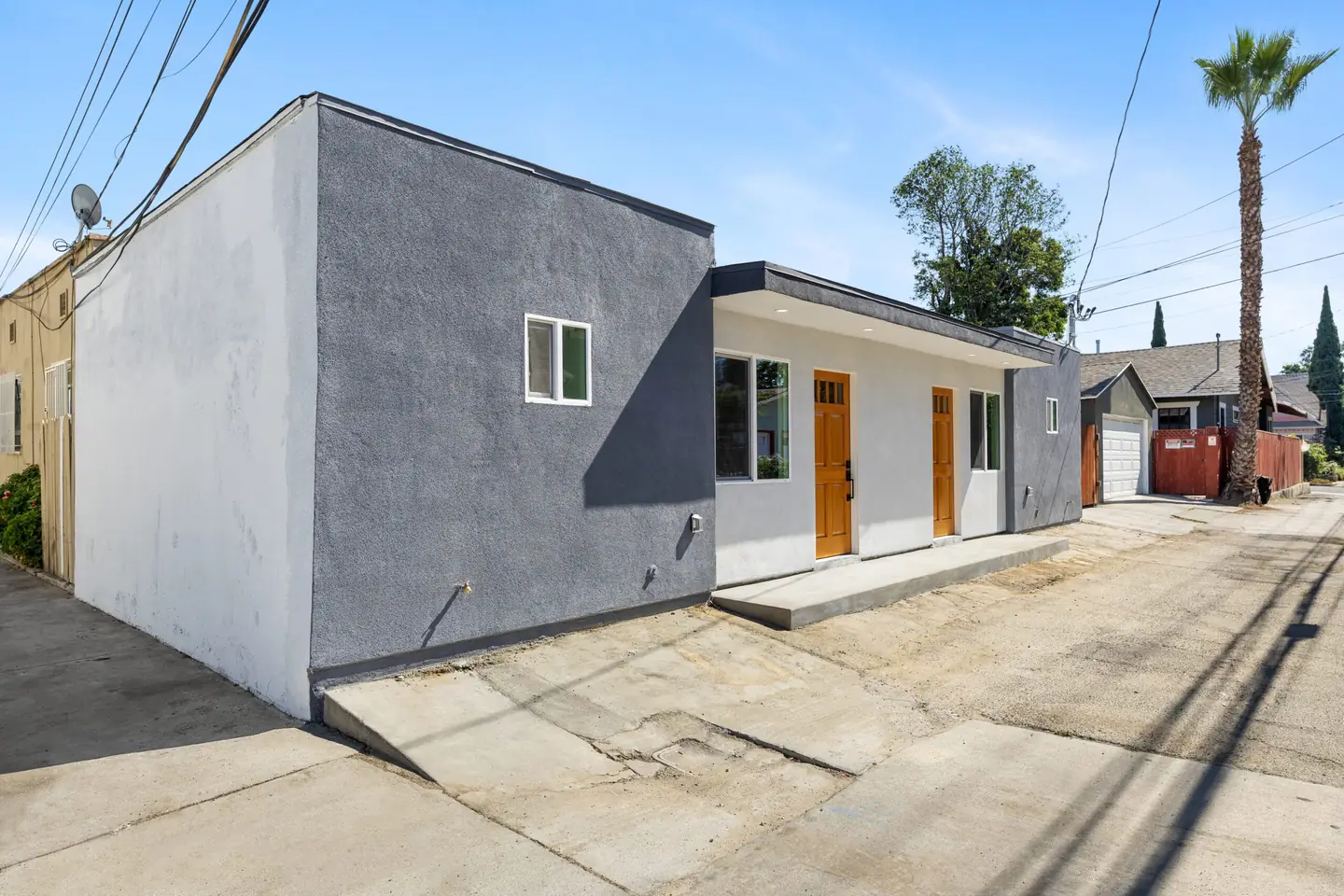 Magnolia: gray and white exterior with wood entry door