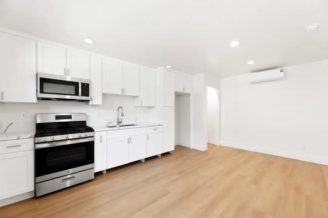 Magnolia: white kitchen beside living area