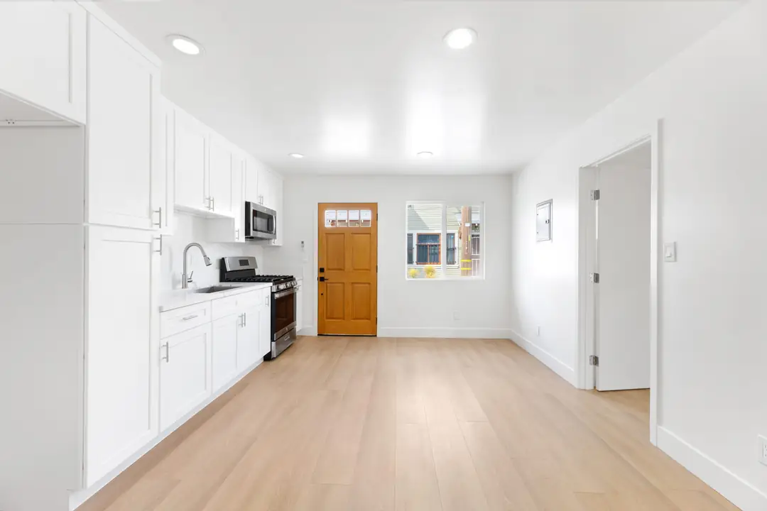 Magnolia: kitchen viewed toward wood entry door