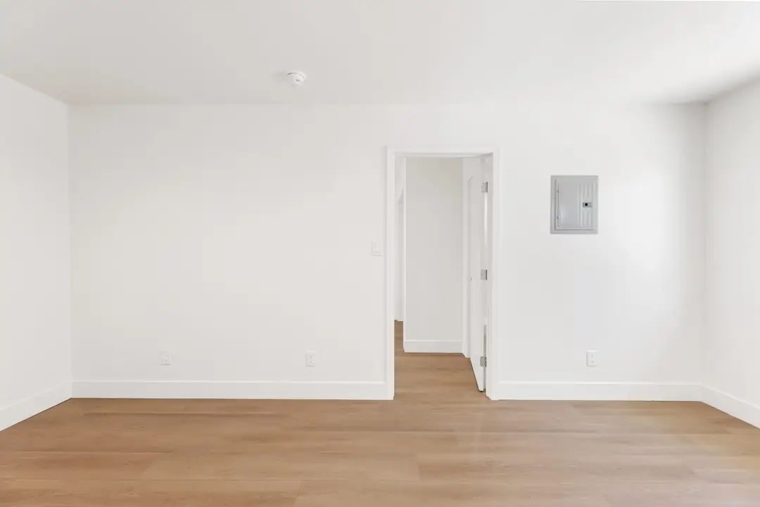 Magnolia: empty interior room with wood toned floor