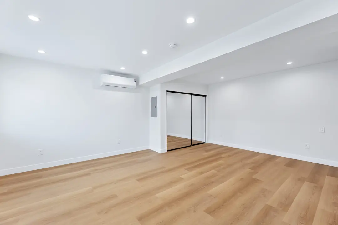 Molino: room with wood toned floor and mirrored storage