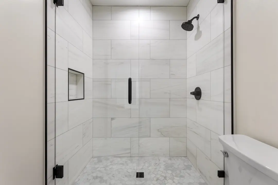 Toledo: tiled shower with dark fittings