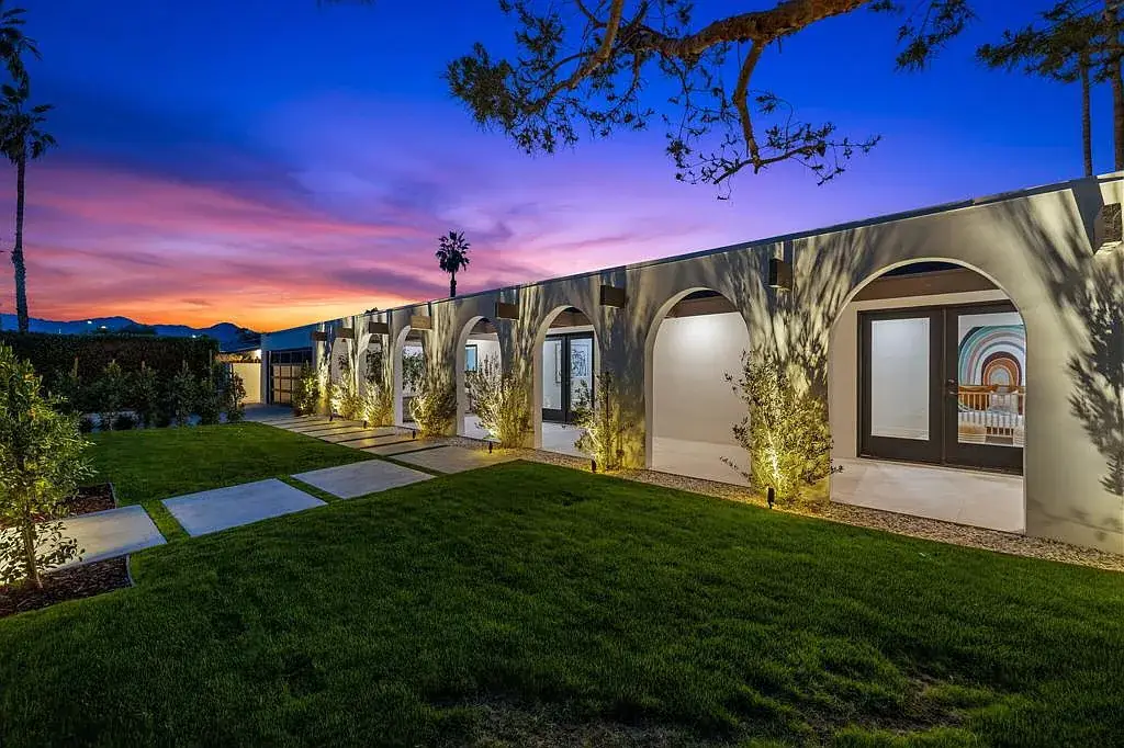 Vista Grande: garden and illuminated arches at dusk